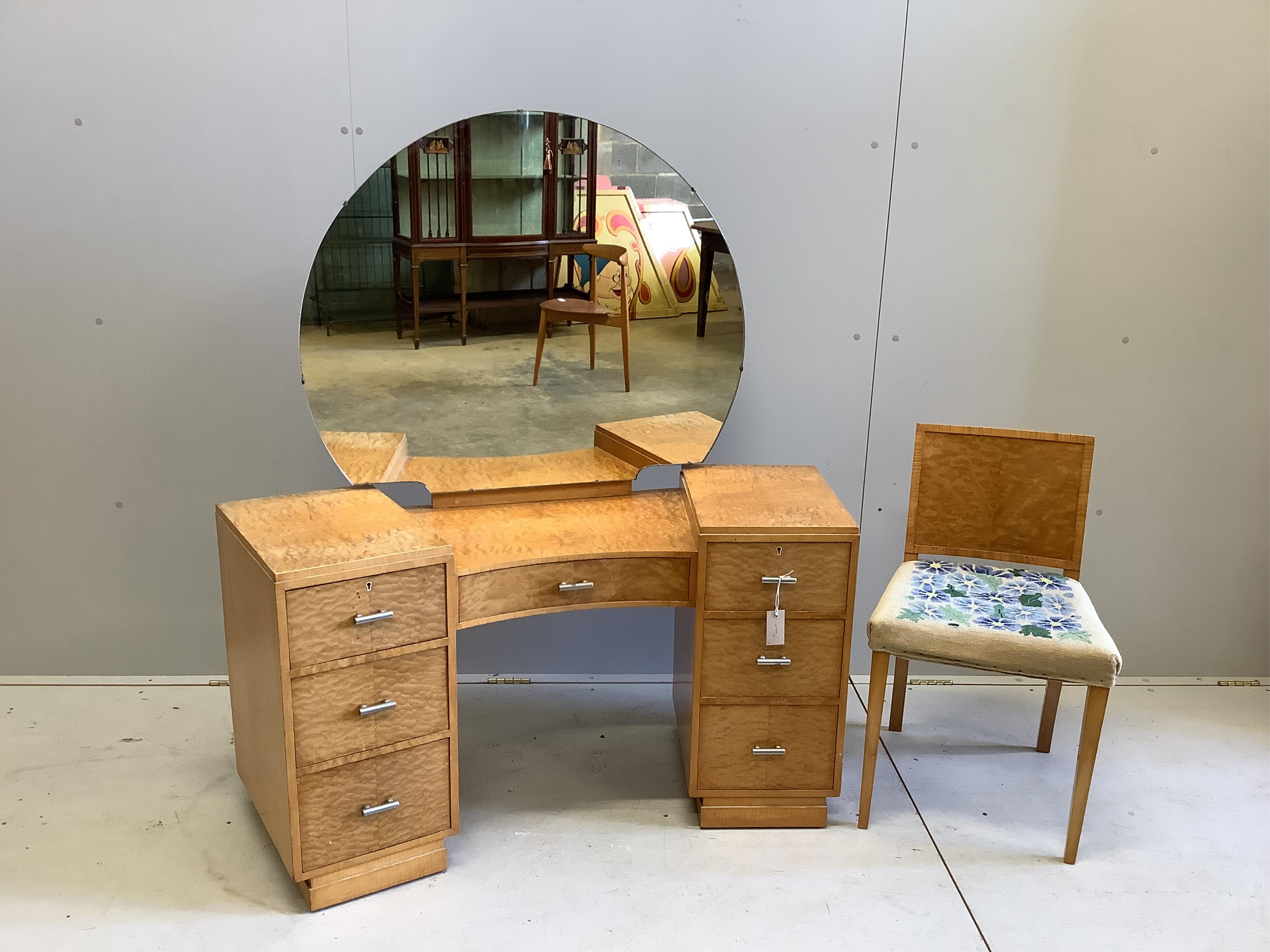 An Art Deco satin maple dressing table and matching chair, width 126cm, height 137cm. Condition - a little faded, otherwise good